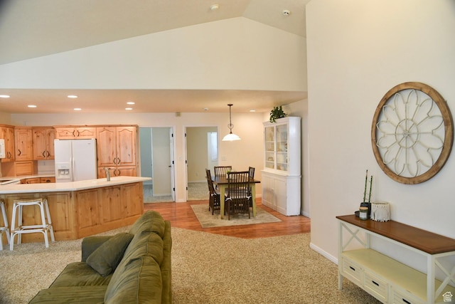 14114 S 3600 W, Bluffdale, UT 84065 - living area featuring recessed lighting, light colored carpet, baseboards, high vaulted ceiling, and light wood-style flooring