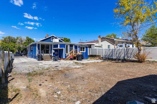 824 N 200 E, Price, UT 84501 - back of property featuring entry steps, a fenced backyard, a sunroom, and a chimney