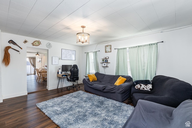 824 N 200 E, Price, UT 84501 - living room featuring plenty of natural light, a chandelier, dark wood-style floors, and baseboards