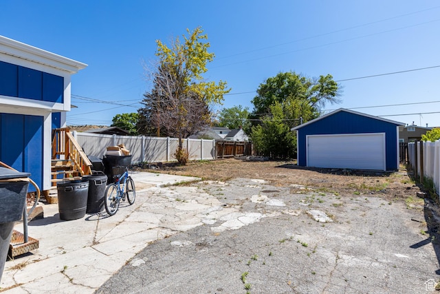 824 N 200 E, Price, UT 84501 - fenced backyard featuring a detached garage, an outdoor structure, and stairs