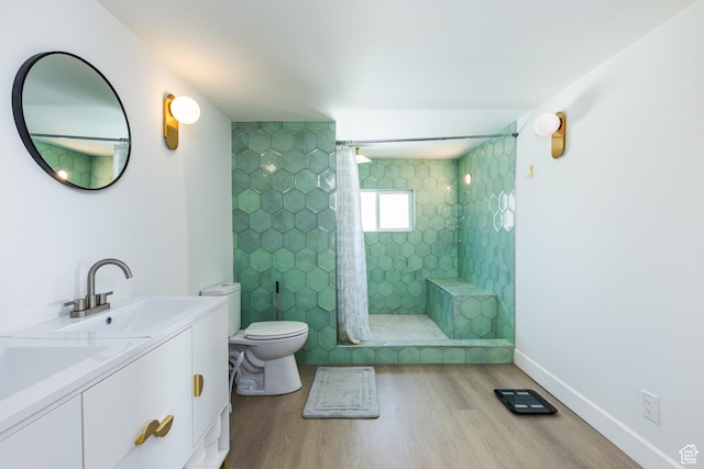 824 N 200 E, Price, UT 84501 - bathroom featuring wood finished floors, toilet, a tile shower, vanity, and baseboards