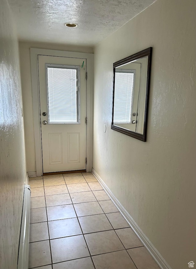 734 S 1300 E, Salt Lake City, UT 84102 - entryway with a baseboard heating unit, light tile patterned floors, a textured ceiling, and baseboards