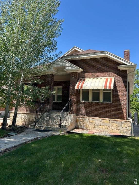 734 S 1300 E, Salt Lake City, UT 84102 - view of front of home featuring brick siding, a front lawn, and a chimney