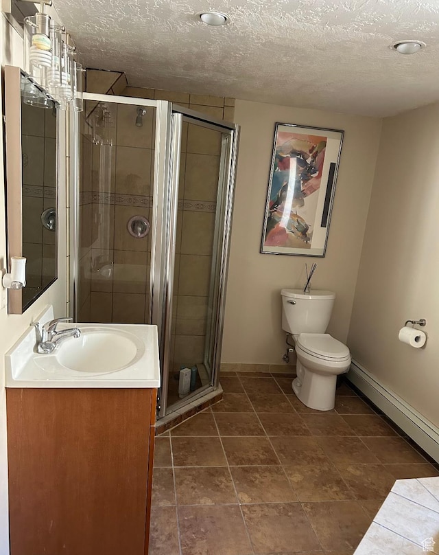 734 S 1300 E, Salt Lake City, UT 84102 - bathroom featuring baseboards, vanity, a textured ceiling, a shower stall, and toilet