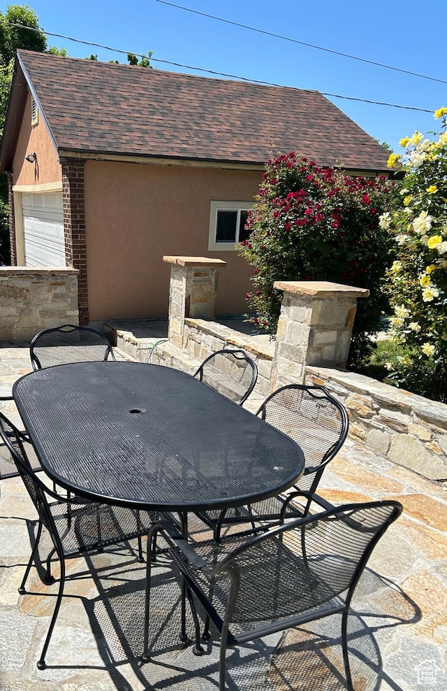 734 S 1300 E, Salt Lake City, UT 84102 - view of patio / terrace featuring outdoor dining space and a garage