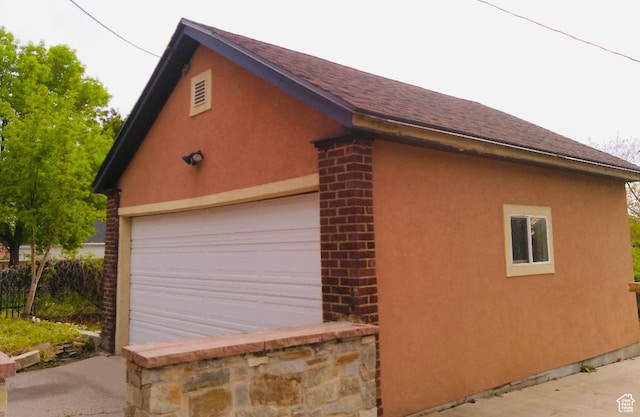 734 S 1300 E, Salt Lake City, UT 84102 - view of side of home with a garage, stucco siding, and roof with shingles