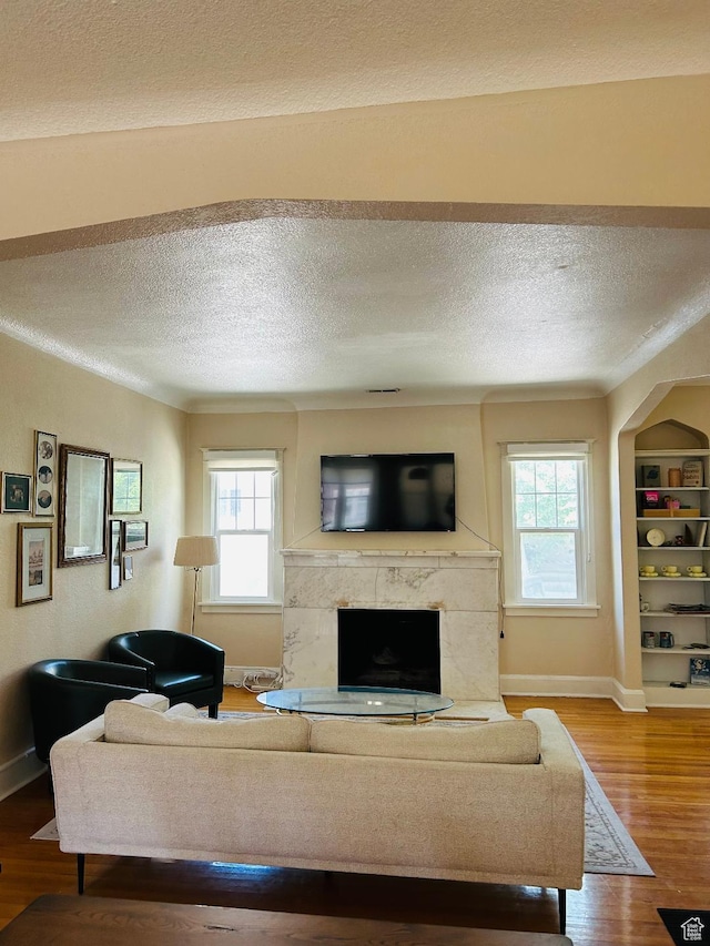 734 S 1300 E, Salt Lake City, UT 84102 - living room featuring baseboards, wood finished floors, healthy amount of natural light, and a textured ceiling