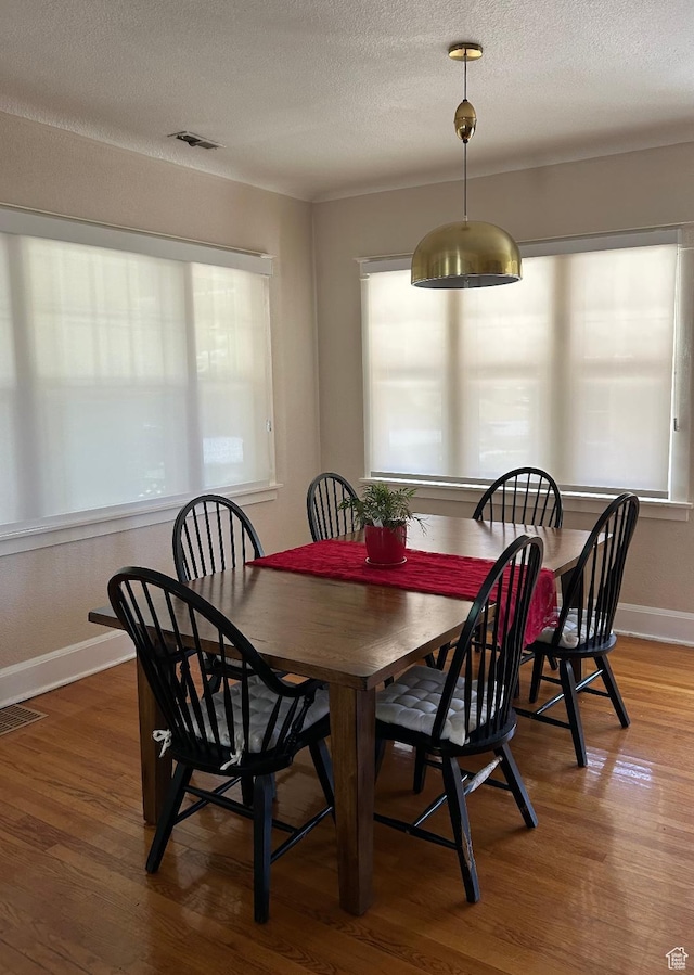 734 S 1300 E, Salt Lake City, UT 84102 - dining area with healthy amount of natural light, wood finished floors, a textured ceiling, and baseboards