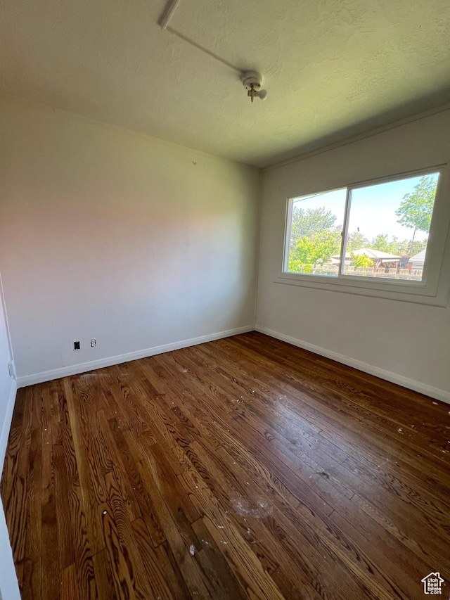 374 S 900 W, Cedar City, UT 84720 - unfurnished room featuring dark wood-type flooring, baseboards, and a textured ceiling
