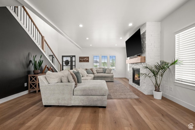 4681 W 75 N, West Point, UT 84015 - living area featuring a fireplace, light wood-type flooring, recessed lighting, baseboards, and stairway