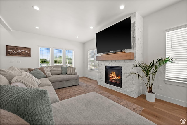 4681 W 75 N, West Point, UT 84015 - living room featuring a stone fireplace, wood finished floors, baseboards, and recessed lighting