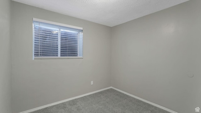 5416 S Capitol Reef Dr, Taylorsville, UT 84129 - carpeted spare room featuring baseboards and a textured ceiling