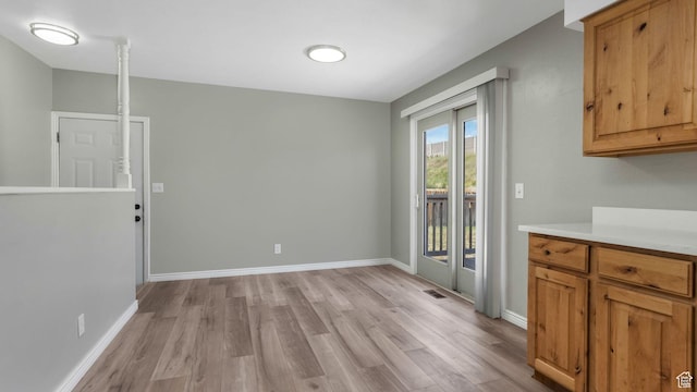 5416 S Capitol Reef Dr, Taylorsville, UT 84129 - unfurnished dining area with light wood-style floors and baseboards