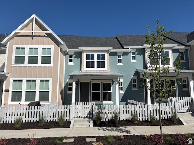 11197 S Rummy Way S, South Jordan, UT 84009 - view of front of property featuring a fenced front yard, roof with shingles, board and batten siding, and covered porch