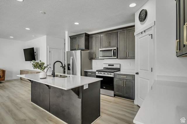 4214 E Sun Crest Dr Unit Lot68, Eagle Mountain, UT 84005 - kitchen featuring appliances with stainless steel finishes, a sink, light wood finished floors, an island with sink, and light countertops