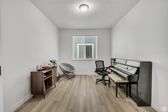 4214 E Sun Crest Dr Unit Lot68, Eagle Mountain, UT 84005 - living area featuring light wood finished floors, baseboards, and a textured ceiling