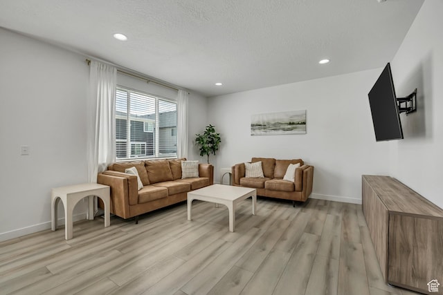 4214 E Sun Crest Dr Unit Lot68, Eagle Mountain, UT 84005 - living area featuring light wood-style flooring, recessed lighting, baseboards, and a textured ceiling