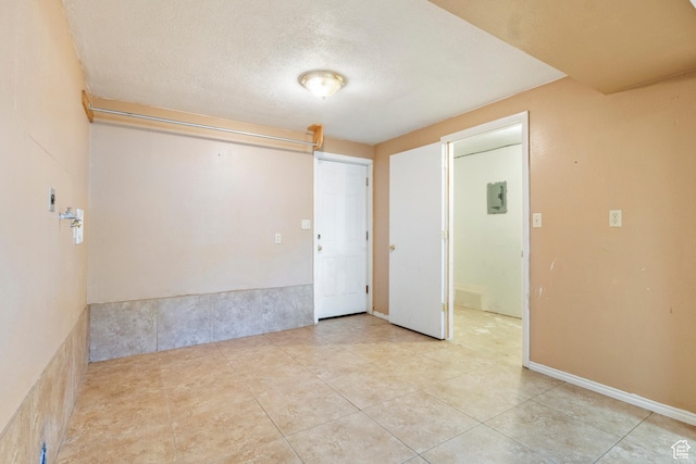 793 E 100 S, Hyrum, UT 84319 - spare room featuring electric panel, light tile patterned floors, and a textured ceiling