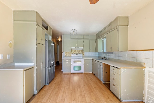 793 E 100 S, Hyrum, UT 84319 - kitchen with white electric range, freestanding refrigerator, a sink, under cabinet range hood, and light wood finished floors
