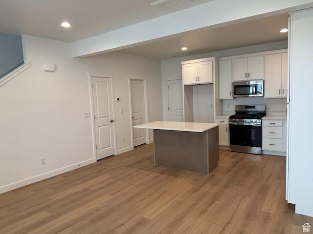 6889 W S Jordan Pkwy, South Jordan, UT 84009 - kitchen featuring stainless steel appliances, white cabinetry, light wood finished floors, recessed lighting, and a kitchen island