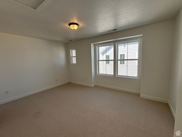 6889 W S Jordan Pkwy, South Jordan, UT 84009 - unfurnished room with baseboards, light carpet, and a textured ceiling
