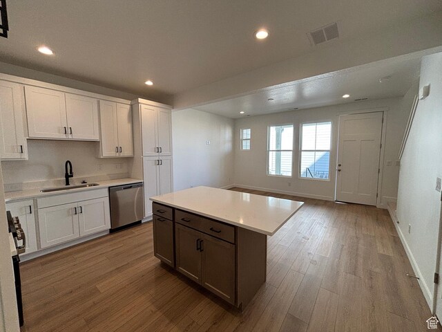 6889 W S Jordan Pkwy, South Jordan, UT 84009 - kitchen with dishwasher, a sink, wood finished floors, recessed lighting, and light countertops