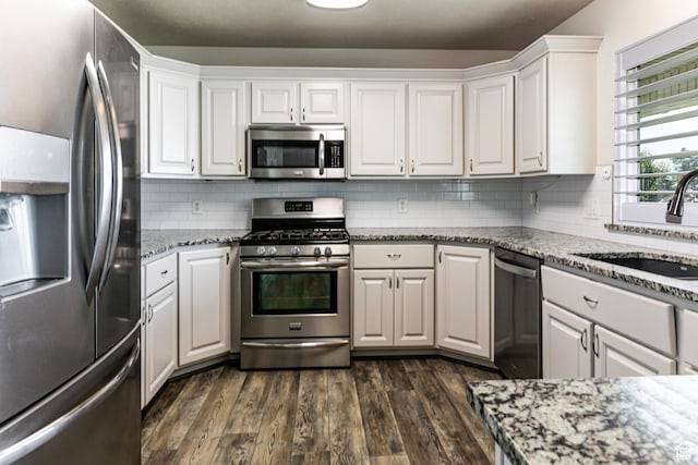3380 S 930 W, Syracuse, UT 84075 - kitchen with appliances with stainless steel finishes, a sink, white cabinets, dark wood finished floors, and light stone countertops