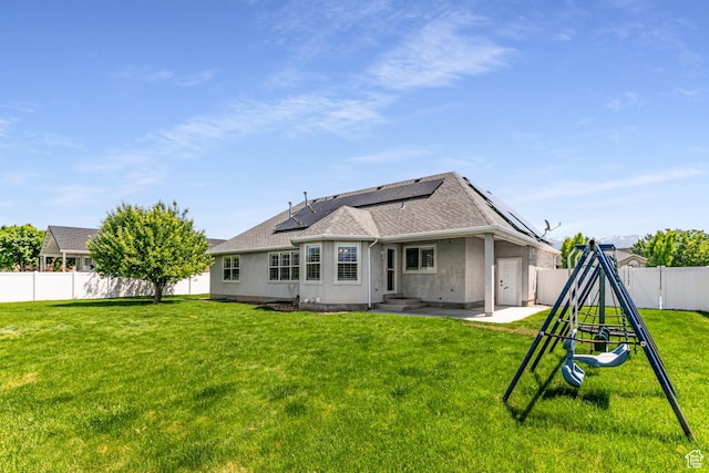 3380 S 930 W, Syracuse, UT 84075 - back of property with solar panels, a patio area, roof with shingles, and stucco siding