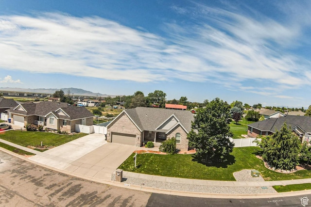 3380 S 930 W, Syracuse, UT 84075 - view of front of house featuring a residential view, concrete driveway, an attached garage, brick siding, and a mountain view