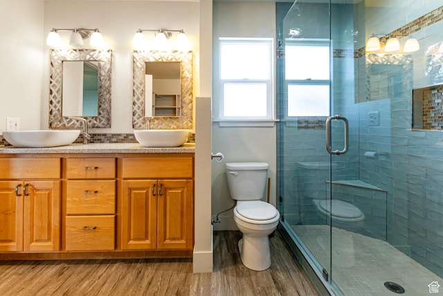 3380 S 930 W, Syracuse, UT 84075 - bathroom with wood finished floors, toilet, double vanity, and a stall shower