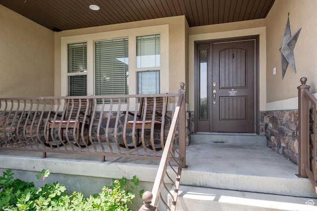 3638 S Blazing Oak Dr, Magna, UT 84044 - property entrance featuring stucco siding, stone siding, and a porch