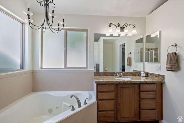 3638 S Blazing Oak Dr, Magna, UT 84044 - full bathroom featuring a chandelier, vanity, a tub with jets, and an enclosed shower