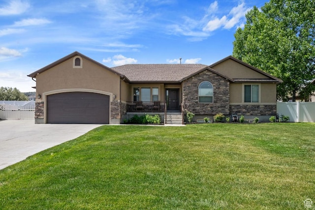 3638 S Blazing Oak Dr, Magna, UT 84044 - ranch-style house with stucco siding, stone siding, concrete driveway, a garage, and covered porch