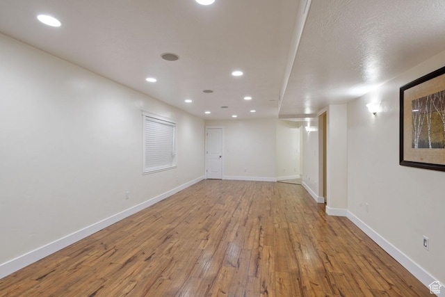 3638 S Blazing Oak Dr, Magna, UT 84044 - finished below grade area with wood-type flooring, recessed lighting, and baseboards