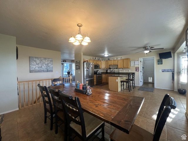 865 E 980 N, Tooele, UT 84074 - tiled dining room with ceiling fan, a chandelier, a sink, and baseboards