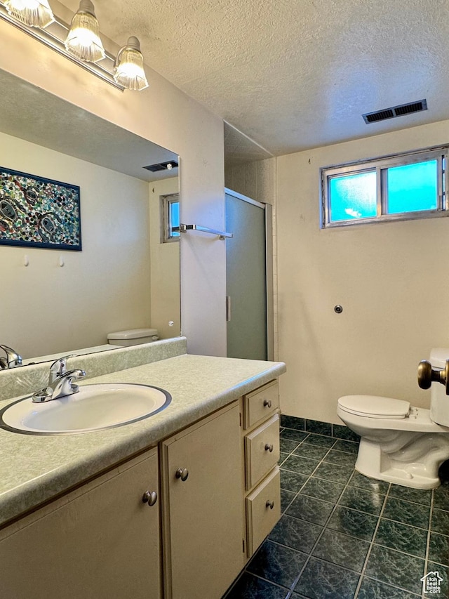 246 N 2800 E, Layton, UT 84040 - bathroom with vanity, a shower stall, a textured ceiling, and tile patterned flooring