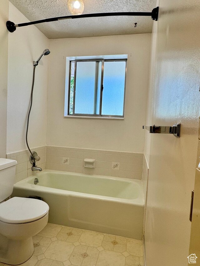 246 N 2800 E, Layton, UT 84040 - full bathroom with tile patterned floors, washtub / shower combination, and a textured ceiling