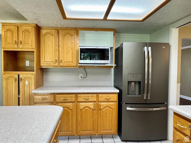 246 N 2800 E, Layton, UT 84040 - kitchen featuring appliances with stainless steel finishes, a textured ceiling, light countertops, and brown cabinets