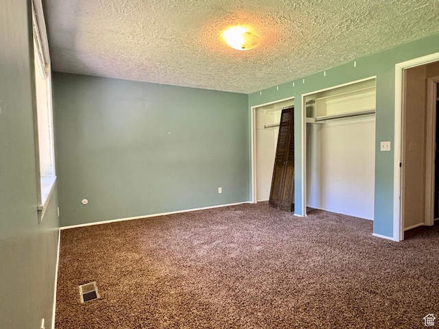 246 N 2800 E, Layton, UT 84040 - unfurnished bedroom with a textured ceiling, multiple closets, and carpet