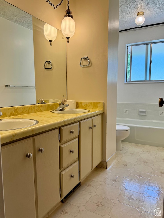 246 N 2800 E, Layton, UT 84040 - full bath featuring double vanity, tile patterned floors, a textured ceiling, and a tub to relax in