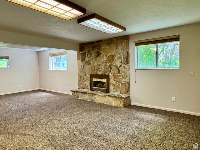 246 N 2800 E, Layton, UT 84040 - unfurnished living room with carpet flooring, a stone fireplace, and a textured ceiling