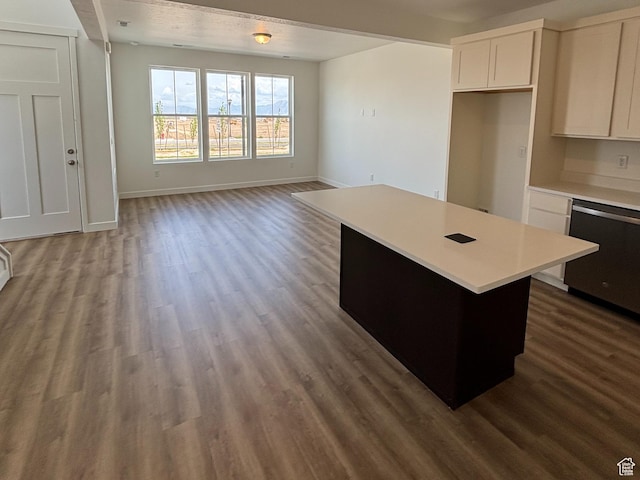 6907 W S Jordan Pkwy, South Jordan, UT 84009 - kitchen with stainless steel dishwasher, a center island, light countertops, and dark wood finished floors