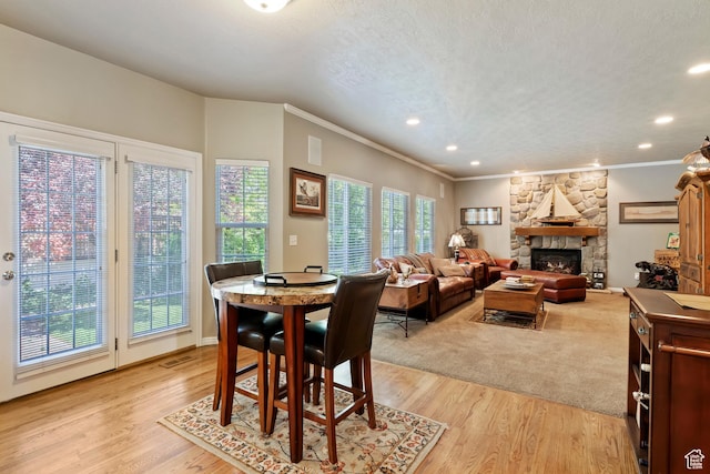 6512 S Timpanogos Way W, Taylorsville, UT 84129 - dining space with a fireplace, crown molding, recessed lighting, and light wood-style floors