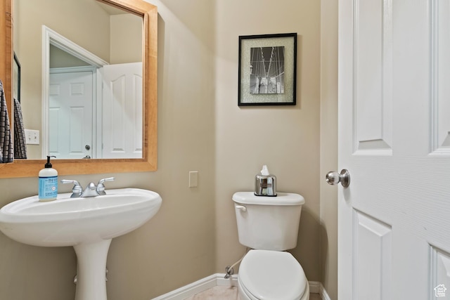 6512 S Timpanogos Way W, Taylorsville, UT 84129 - half bathroom with baseboards, toilet, and a sink