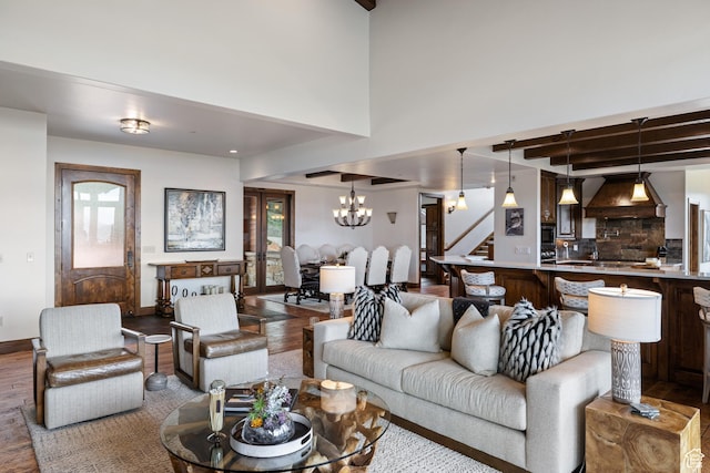 2314 E Flattop Mountain Dr Unit 89, Heber City, UT 84032 - living room featuring wood finished floors, a chandelier, stairway, beamed ceiling, and baseboards