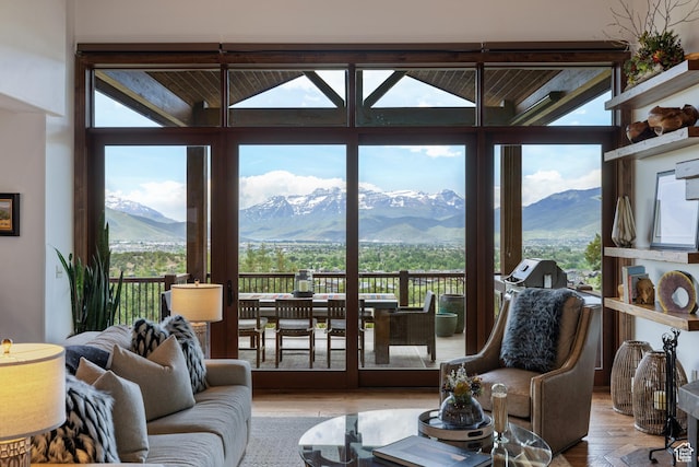 2314 E Flattop Mountain Dr Unit 89, Heber City, UT 84032 - living area with healthy amount of natural light, a mountain view, wood finished floors, floor to ceiling windows, and vaulted ceiling