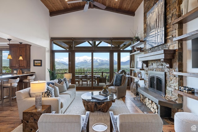 2314 E Flattop Mountain Dr Unit 89, Heber City, UT 84032 - living room with high vaulted ceiling, a mountain view, a ceiling fan, wood finished floors, and a stone fireplace