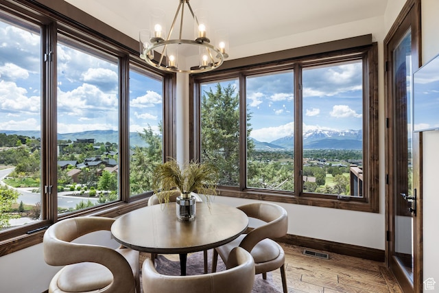 2314 E Flattop Mountain Dr Unit 89, Heber City, UT 84032 - dining space featuring a chandelier, a mountain view, baseboards, and light wood-type flooring