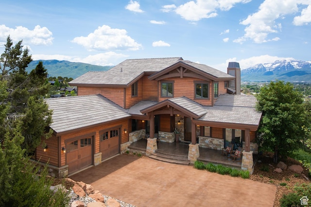 2314 E Flattop Mountain Dr Unit 89, Heber City, UT 84032 - chalet / cabin featuring a porch, a mountain view, a chimney, concrete driveway, and a garage