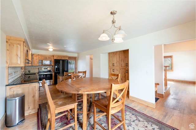 2003 Venus Ct, Park City, UT 84060 - dining space featuring light wood-type flooring, a chandelier, and baseboards